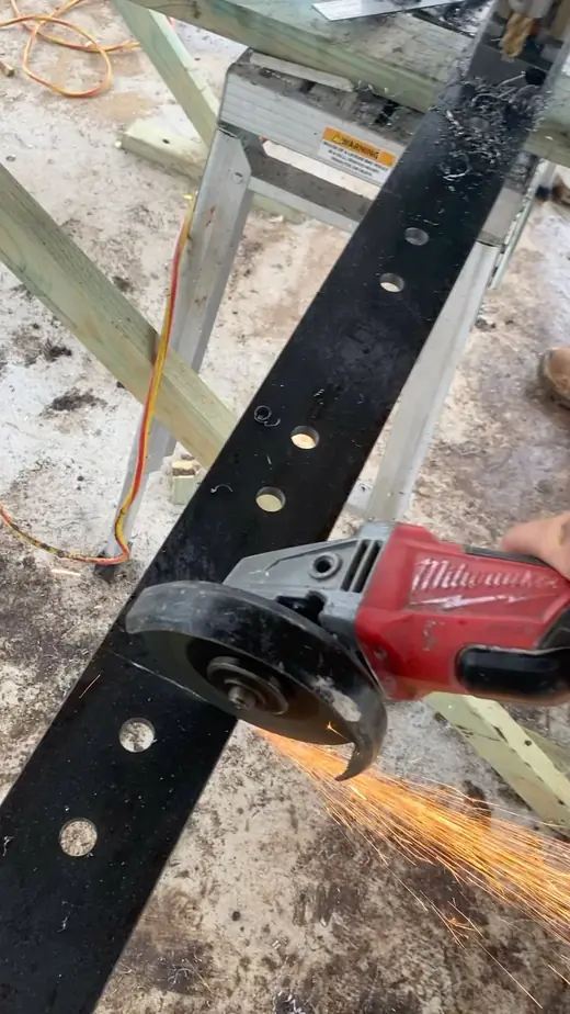 Angle grinder cutting a steel plate with sparks