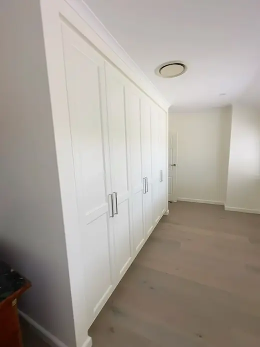 White built-in wardrobe with panel doors