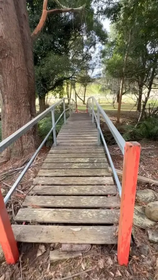 Galvanised steel handrail beside timber steps