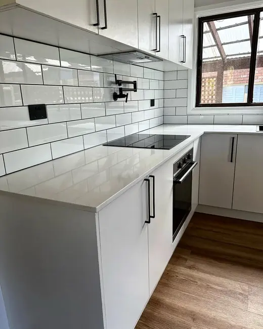 Renovated kitchen with white subway tile splashback