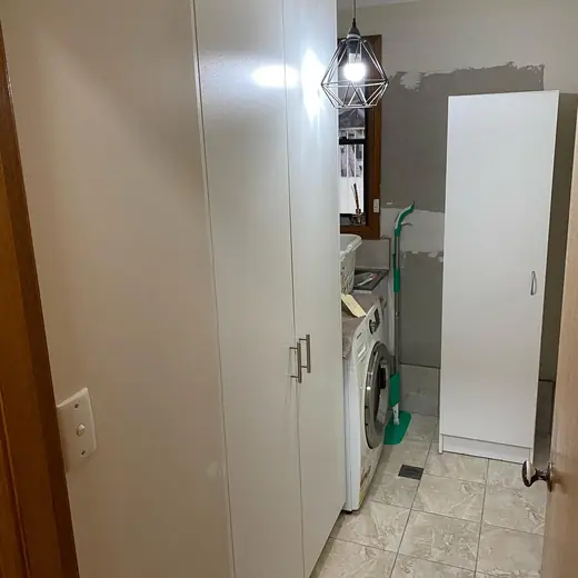 Laundry with freshly installed cabinets