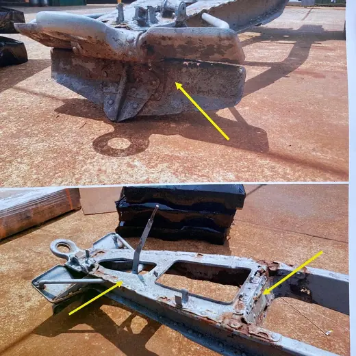 Cracked and rusted steel bracket marked for weld repair