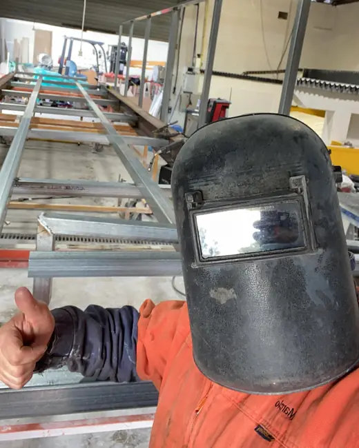 Welding mask and steel frames in a fabrication workshop